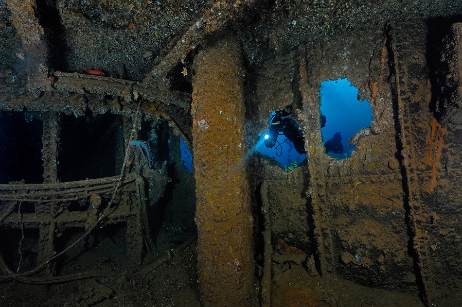 Scuba diver at japanese wreck fujikawa maru, truk lagoon, micronesia, pacific ocean, chuuk